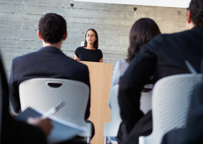 Businessman Delivering Presentation At Conference