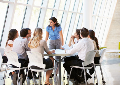 Business People Having Board Meeting In Modern Office
